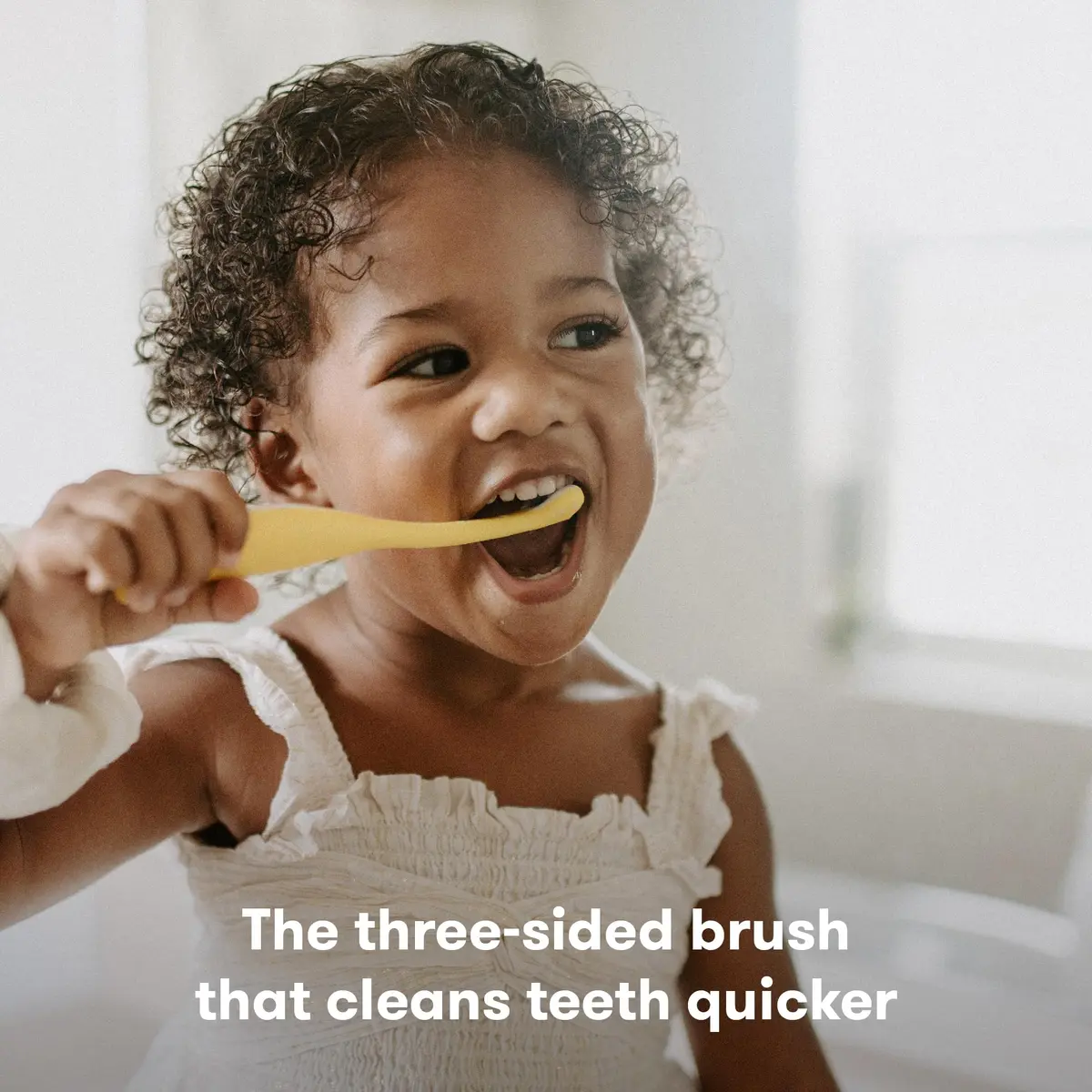 Frida Baby Triple-Angle Toothhugger Training Toddler Toothbrush | Toddler Toothbrush 2 Years and Up, Cleans All Sides at Once, Yellow (1 Count) - view 2