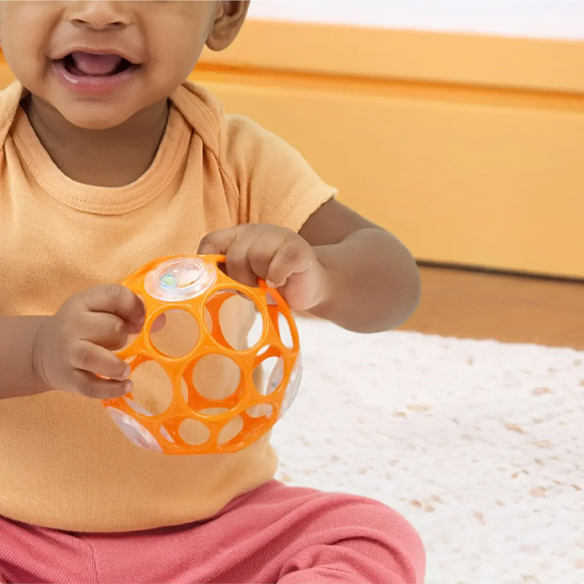 Bright Starts Oball Rattle Ball, Easy-Grasp Infant Toy with Finger Holes, Orange, 0-10cm (4in) - view 9